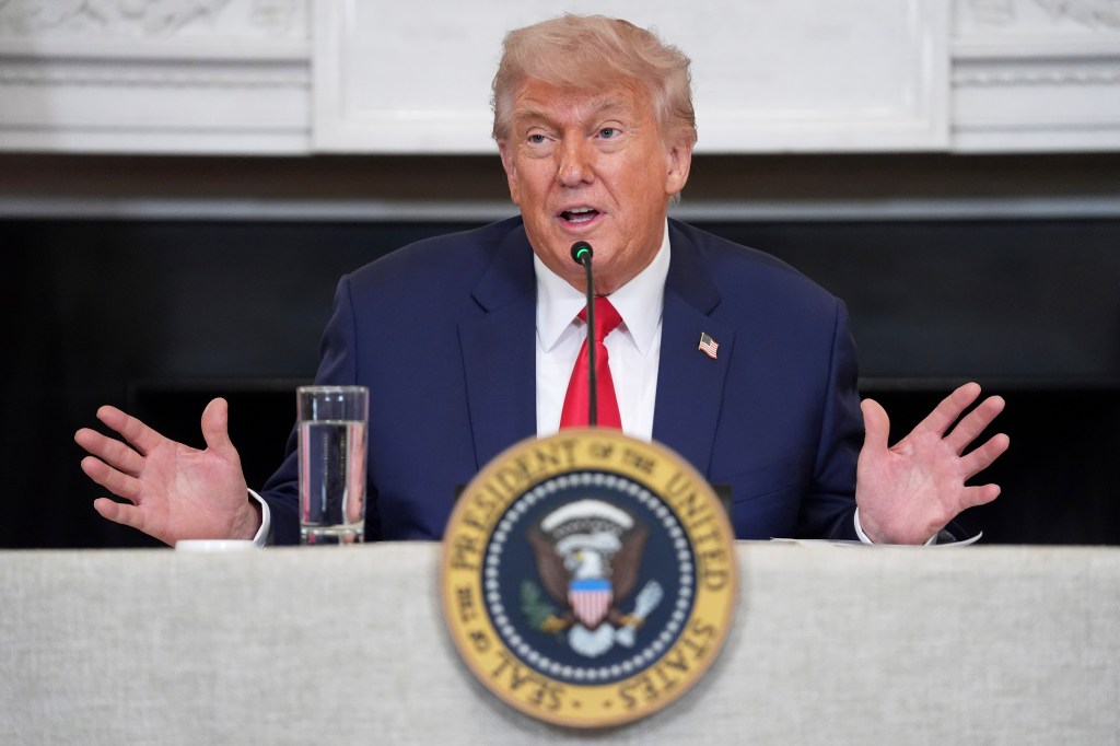 Donald Trump talking on a podium.